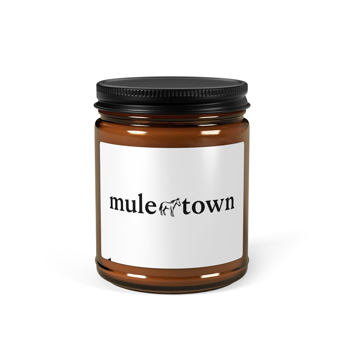 Brown candle jar with black lid and 'mule town' label on a white background
