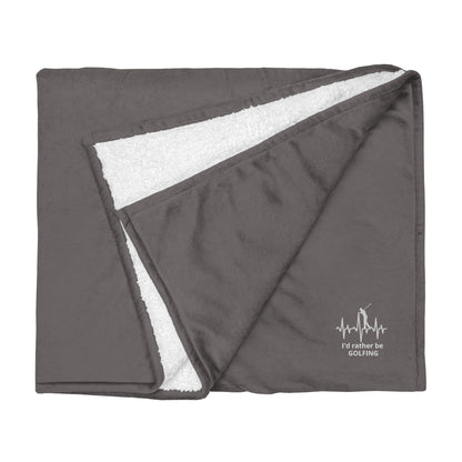 Gray blanket with white fleece lining and 'I'd rather be golfing" branding on a white background