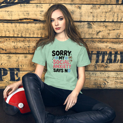Woman wearing a green t-shirt with text sitting against a wooden wall.