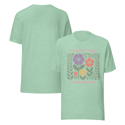 Light green t-shirt with floral design and text on a white background