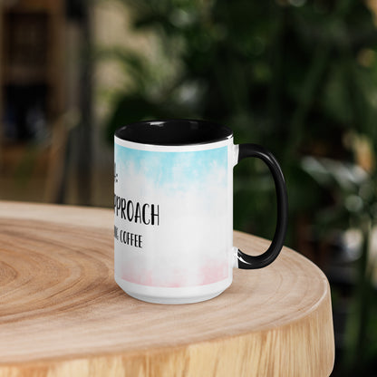 Mug with text and colorful design on a wooden surface with a blurred background